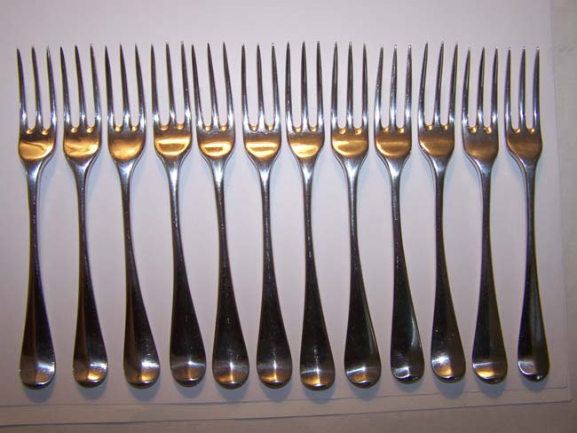 A Fine and Rare Set of 12 English Silver Three-Prong Dessert Forks by Ebenezer Coker, London 1748, each with a 'Coronet' crest.